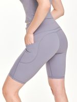 Close-up side view of the BEYOURA Elliana Sculpted luxeFIT Biker Shorts in blue with pockets