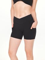 Close-up front view of model posing in the BEYOURA Elliana V-Line luxeFIT Shorts in black with hands in pocket