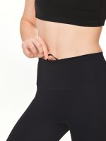 Close-up front view of the BEYOURA Estelle Stretch & Stash luxeFIT Leggings in black with an adjustable waistband