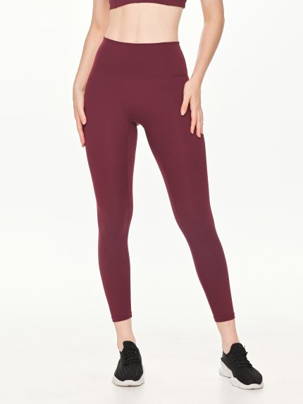 Close-up front view of the BEYOURA Estelle Stretch & Stash luxeFIT Leggings in maroon