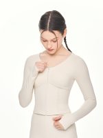 Close-up front view of model posing with the zipper of the BEYOURA Madeleine Body Hugging luxeFIT Jacket in off-white