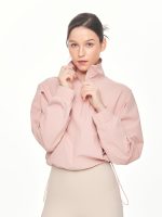 Close-up front view of model posing with the zipper of the BEYOURA Madeleine Cropped luxeFIT Lightweight Pullover in pink