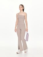 Full side-front view of the BEYOURA Charlotte Asymmetrical luxeFIT Top in grey styled with a headband and water bottle