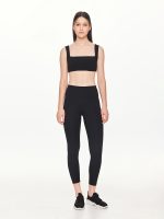 Full front view of the BEYOURA Giselle Broad Strap luxeFIT Sports Bra in black styled with black leggings
