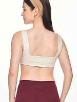 Close-up back view of the BEYOURA Giselle Broad Strap luxeFIT Sports Bra in off-white showing thick supportive straps