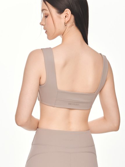 Close-up back view of the BEYOURA Giselle Broad Strap luxeFIT Sports Bra in taupe showing thick supportive straps