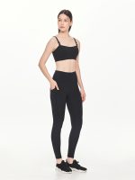 Full side-front view of the BEYOURA Giselle Duostrap luxeFIT Sports Bra in black styled with black leggings