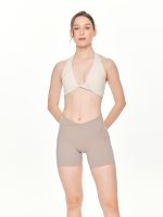 Medium close-up front view of the BEYOURA Giselle Halter luxeFIT Sports Bra in off-white
