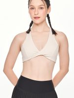 Close-up front view of the BEYOURA Giselle Twist Strap luxeFIT Sports Bra in off-white
