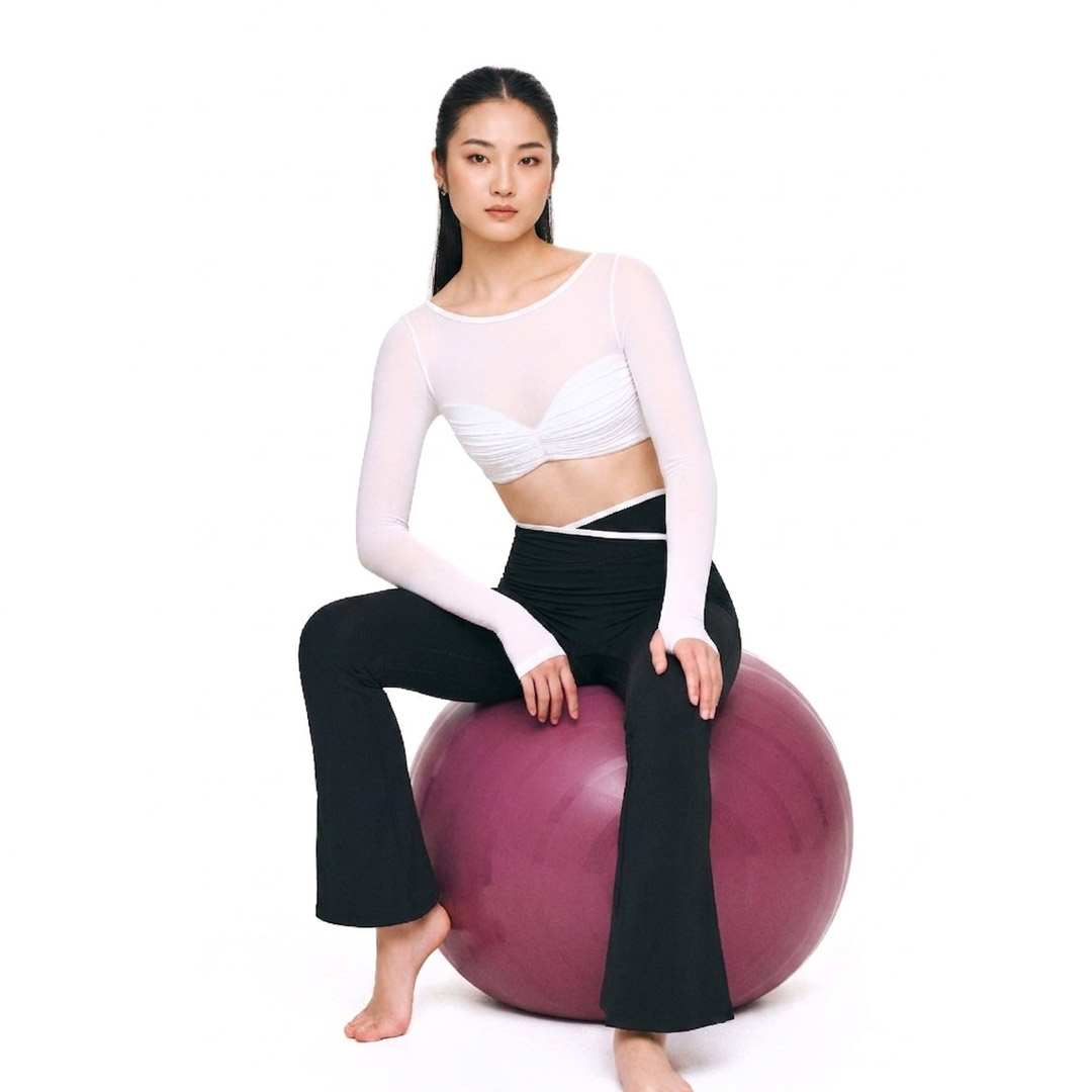 Beyoura--Woman-on-yoga-ball Asian woman resting after exercise in breathable activewear, reflecting sweat-ready comfort for Malaysia’s humid weather.